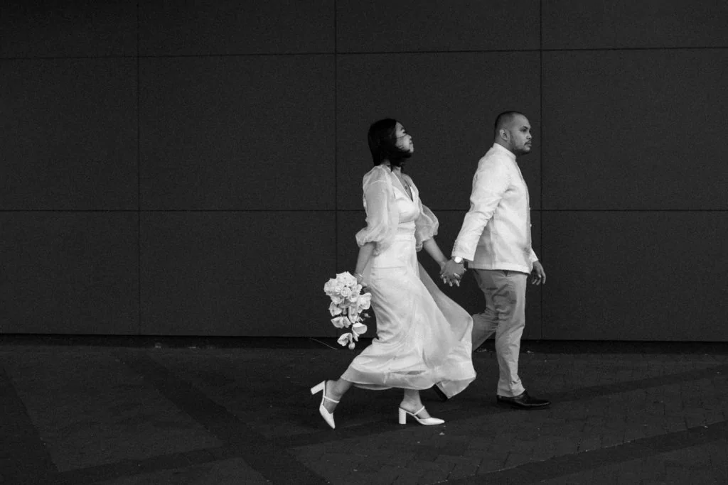 bride with bouquet and groom walking together in Norfolk Virginia for their courthouse elopement
