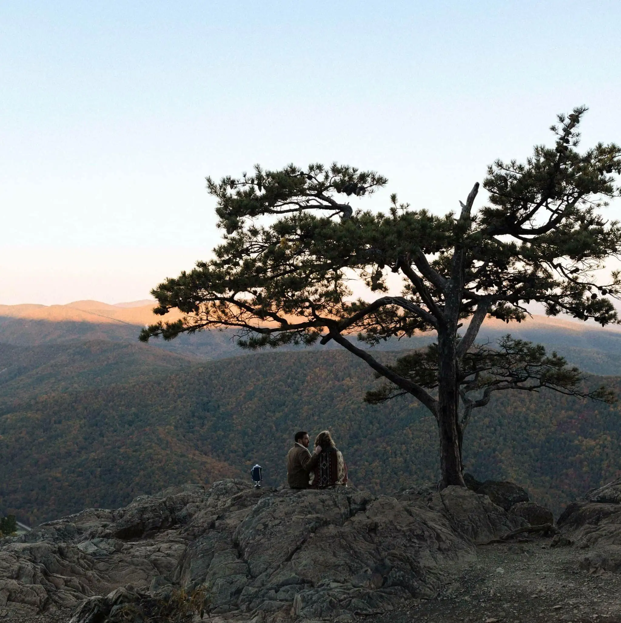 a couple on the morning of their wedding sharing coffee watching the sunrise over the Blue Ridge Mountains