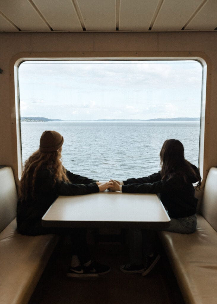 a couple looks out of the window of the seattle ferry